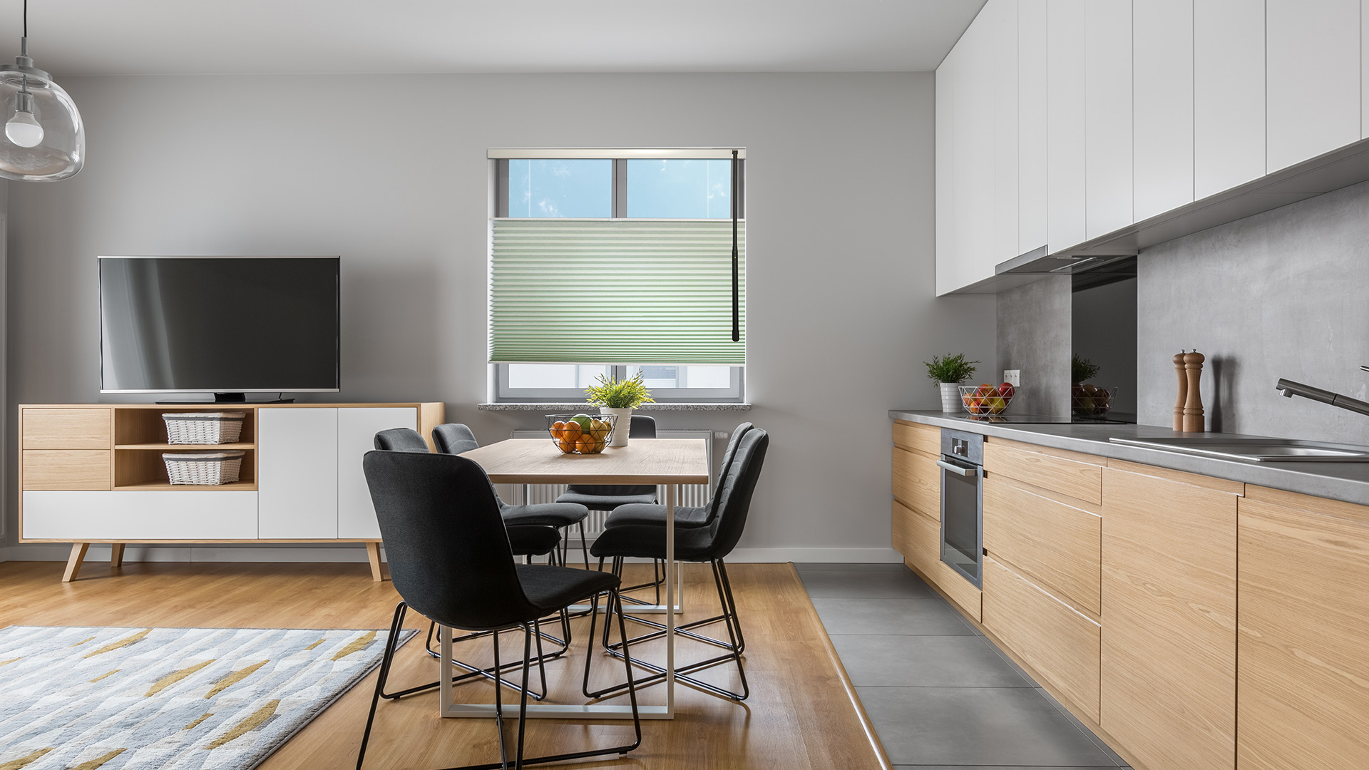 Bright kitchen with solar shades filtering glare.
