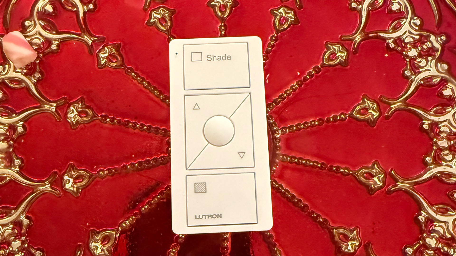 Close-up of a Lutron remote or phone app controlling shades.