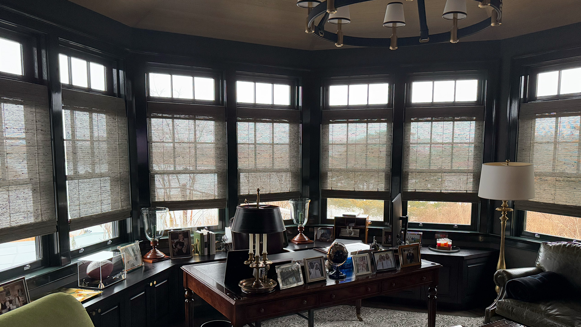 Sunlight filtering through sheer shades in a historic study.