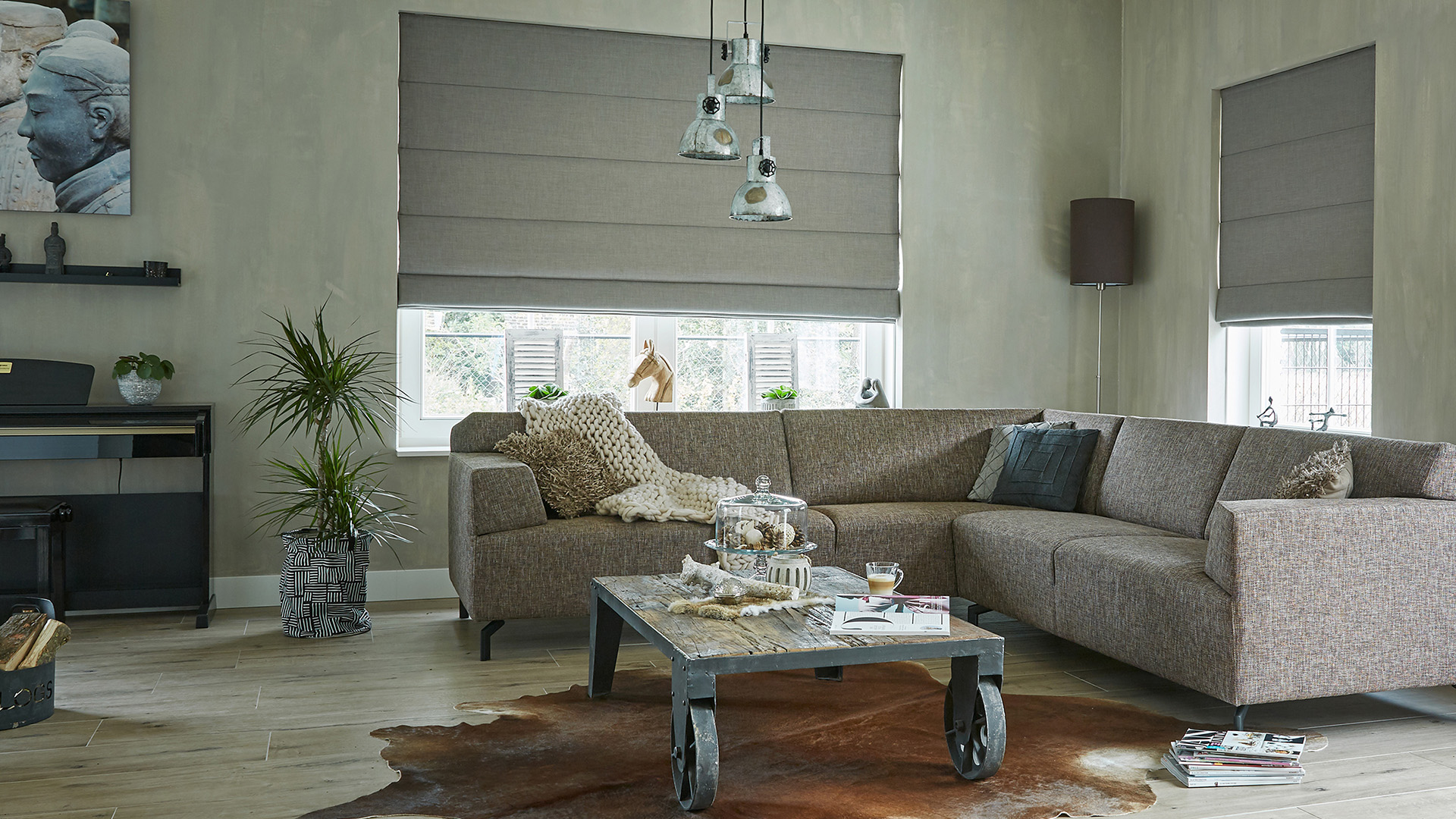 Elegant Roman shades in a sitting room, moving automatically.
